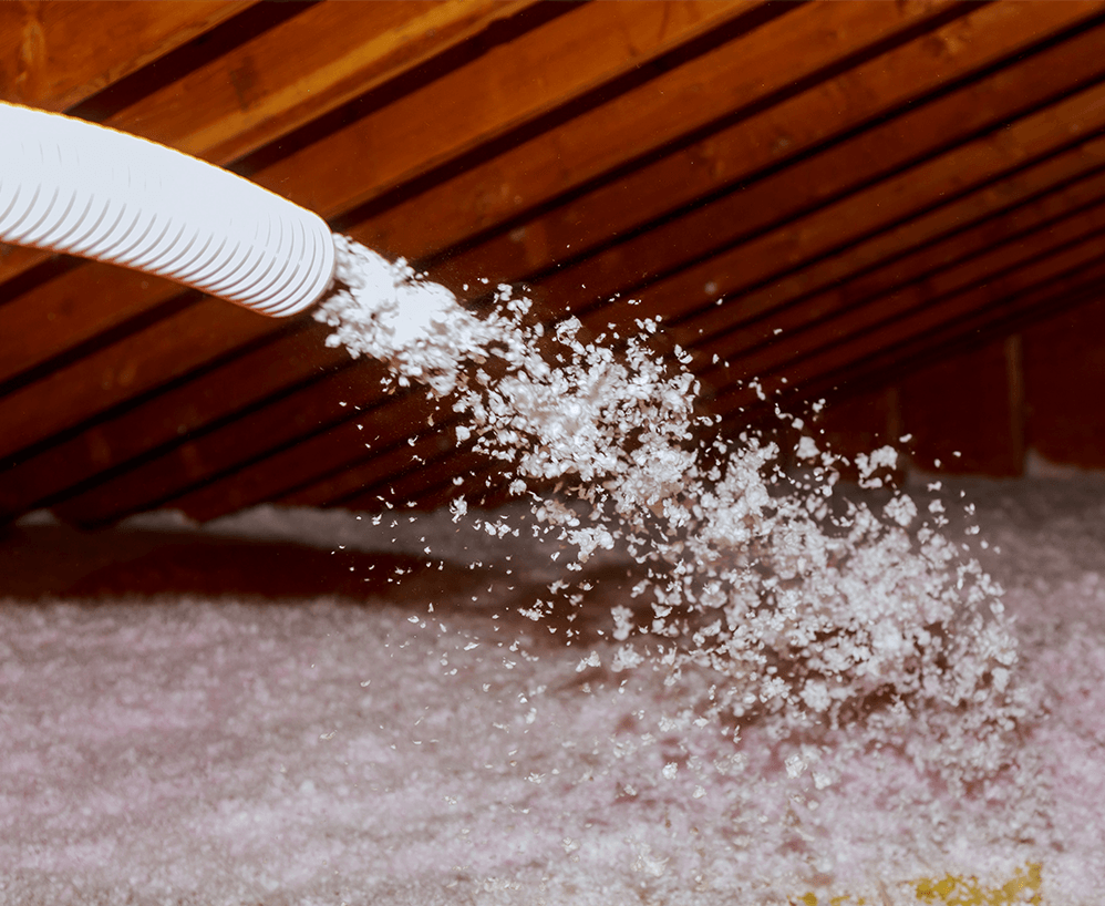 Insulation being blown into roof attic